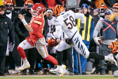 Kansas City Chiefs quarterback Patrick Mahomes ducks out of bounds while being pursued by Cincinnati Bengal Joseph Ossai