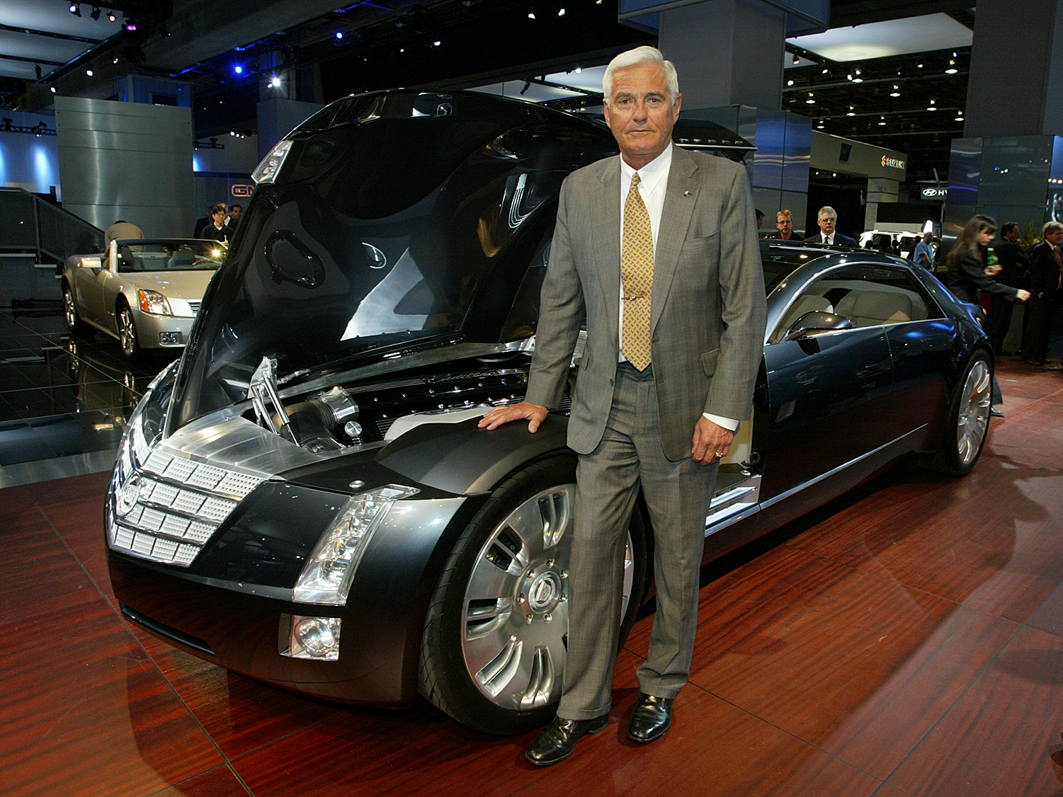 Robert A. Lutz, GM vice chairman for product development, stands with the 2003 Cadillac Sixteen concept car at the North American International Auto Show in Detroit, MI on January 6, 2003