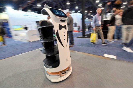 A Pudu BellaBot delivery robot moves through a booth during at CES 2023 at the Las Vegas Convention Center on January 05, 2023 in Las Vegas. Some critics claim too much of the tech at CES didn't keep privacy or digital security in mind for consumers