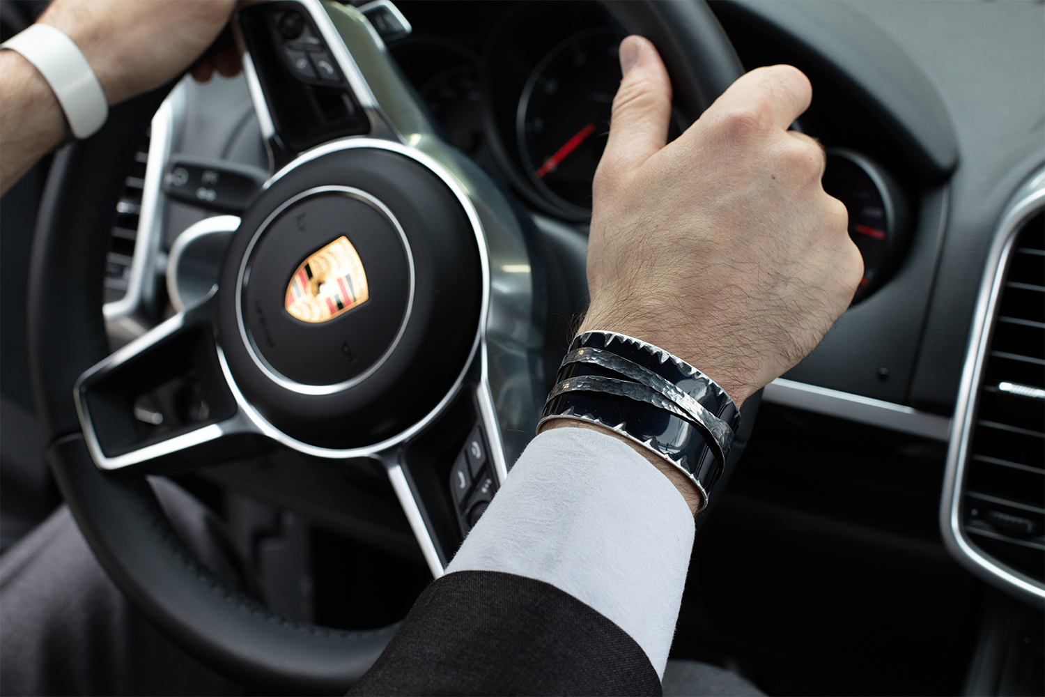The Bentley Arnage Cuff by Crash Jewelry, seen here on a man's wrist, is made from the fender of a Bentley Arnage Limousine