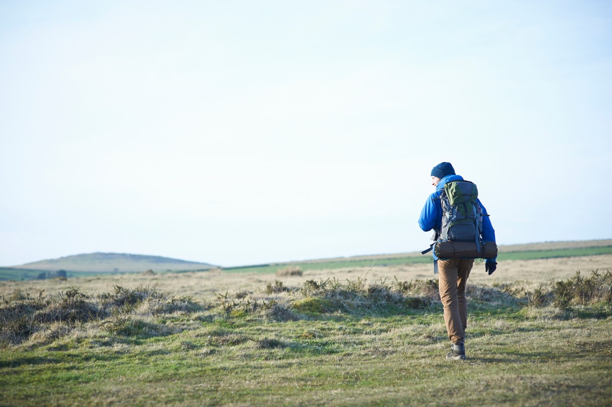 A backpacker in an open field.