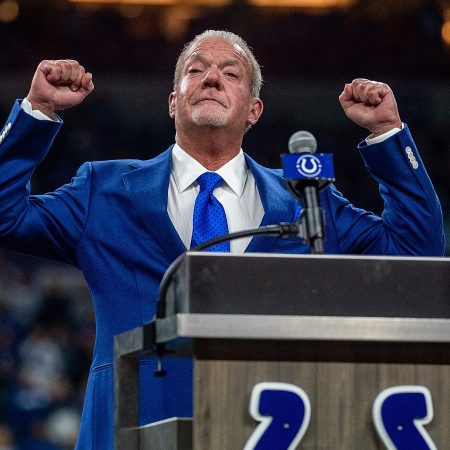 Indianapolis Colts owner Jim Irsay on stage in a blue suit and blue tie