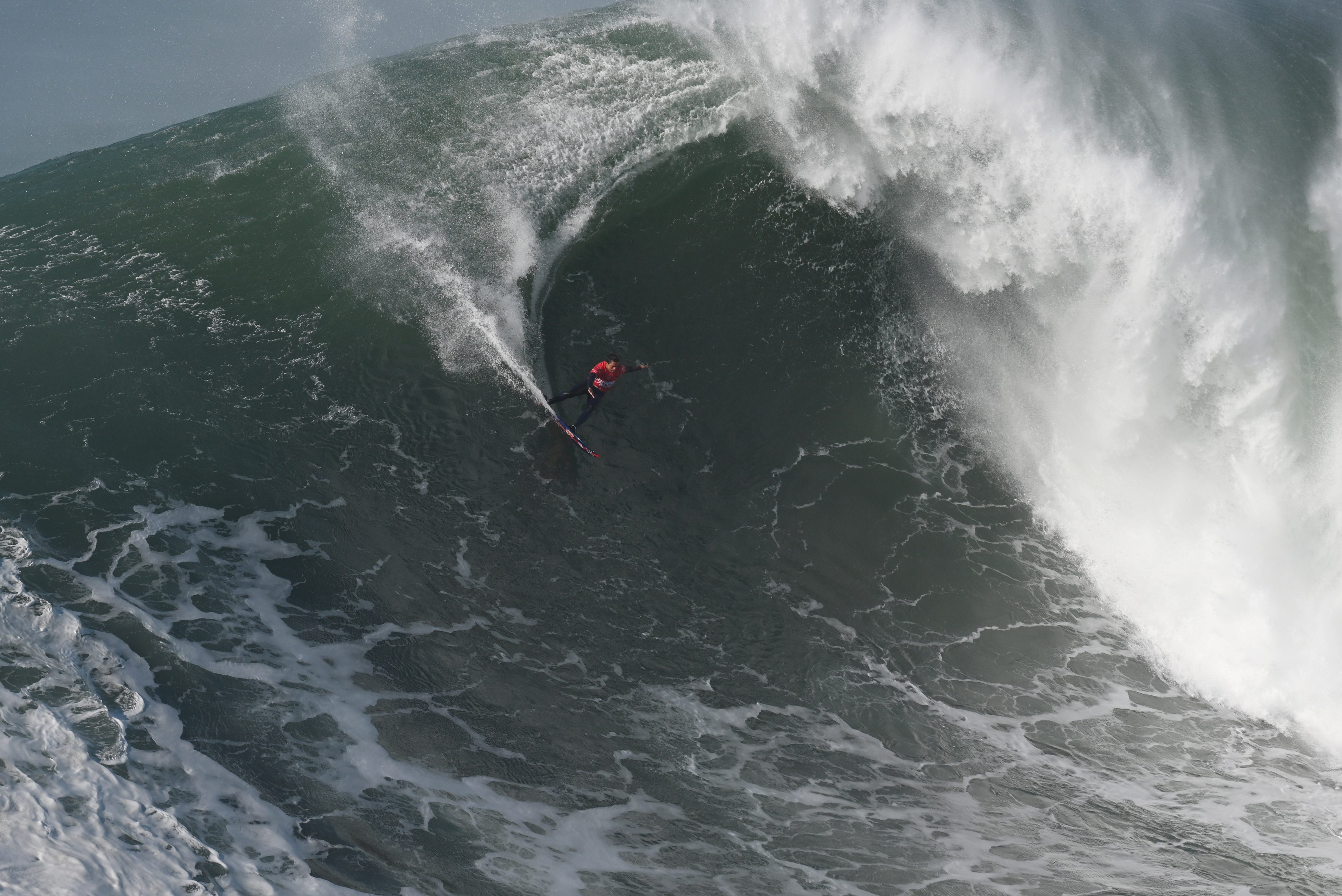 Big wave surfer Kai Lenny rides a wave in 2021 in Nazare.