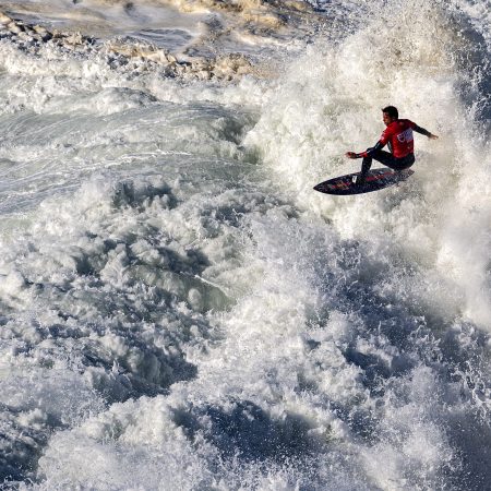 Kai Lenny rides a wave during the TUDOR Nazare Tow Surfing Challenge in 2021.