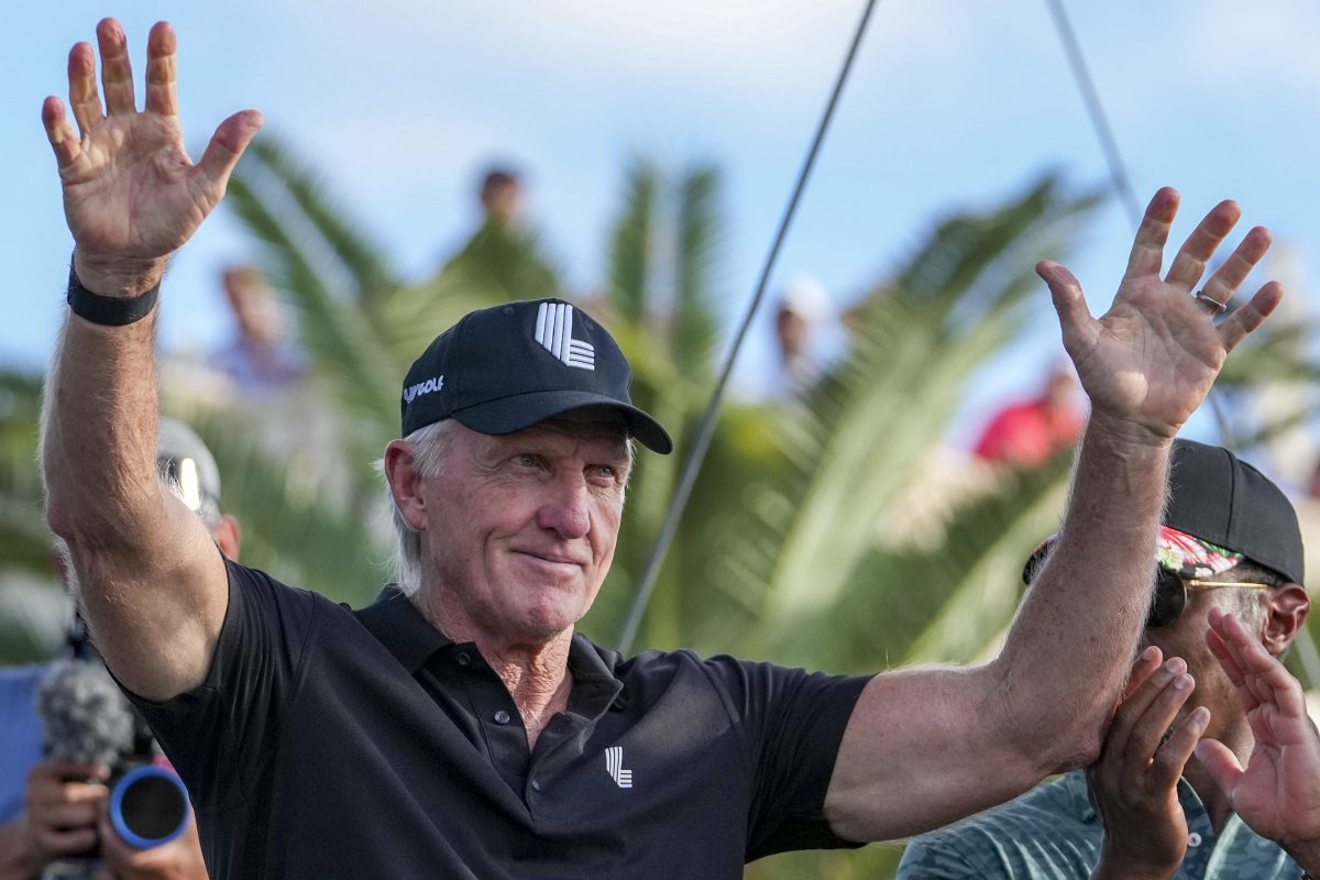 LIV Golf CEO Greg Norman waves to a crowd.