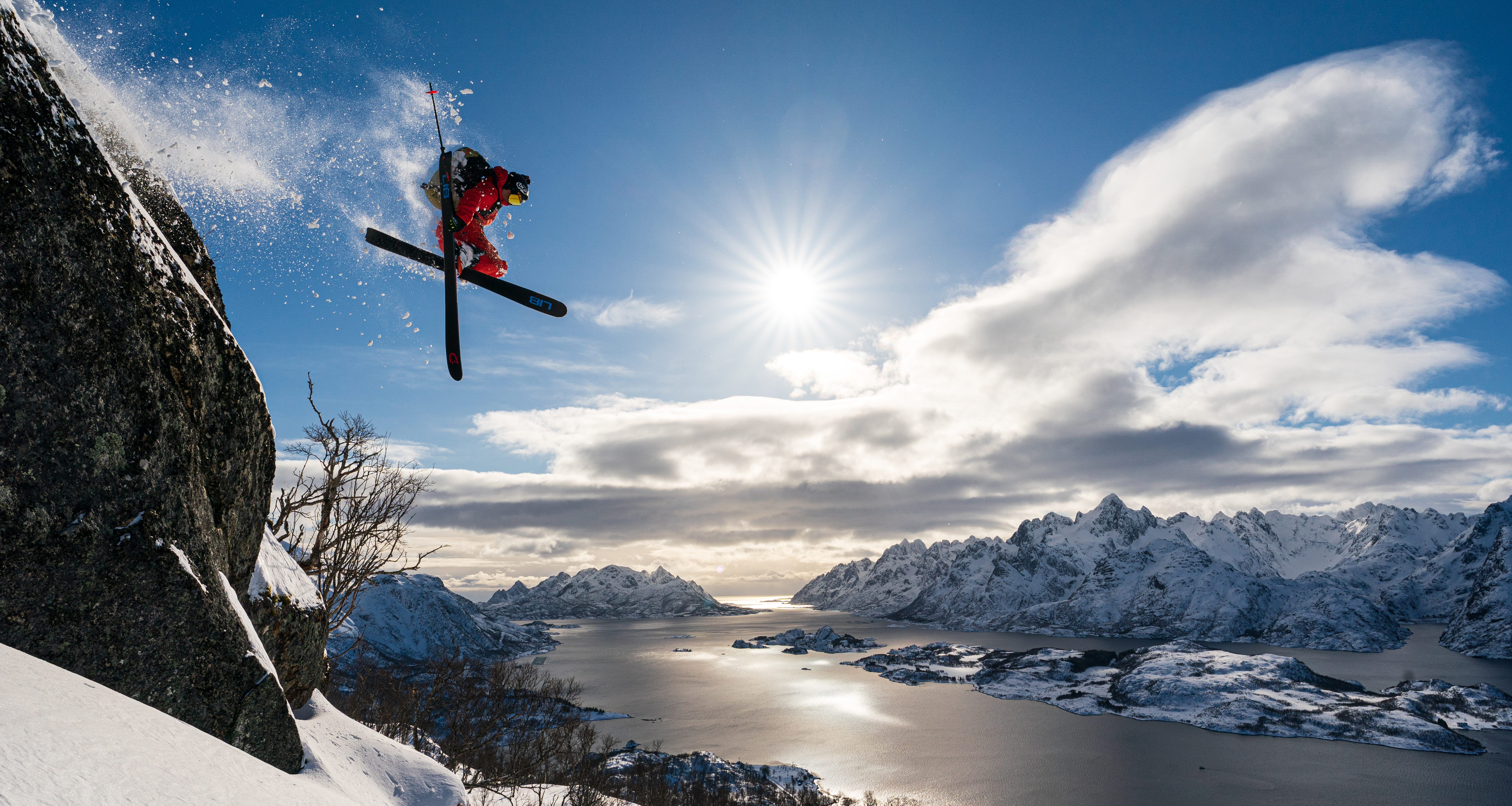 Skier Adam Ü jumping off a cliff in Norway's Lofoten Islands