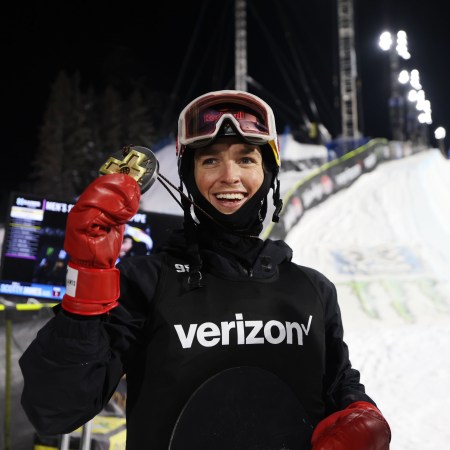 Scotty James holds up a medal after winning the halfpipe at the X Games.