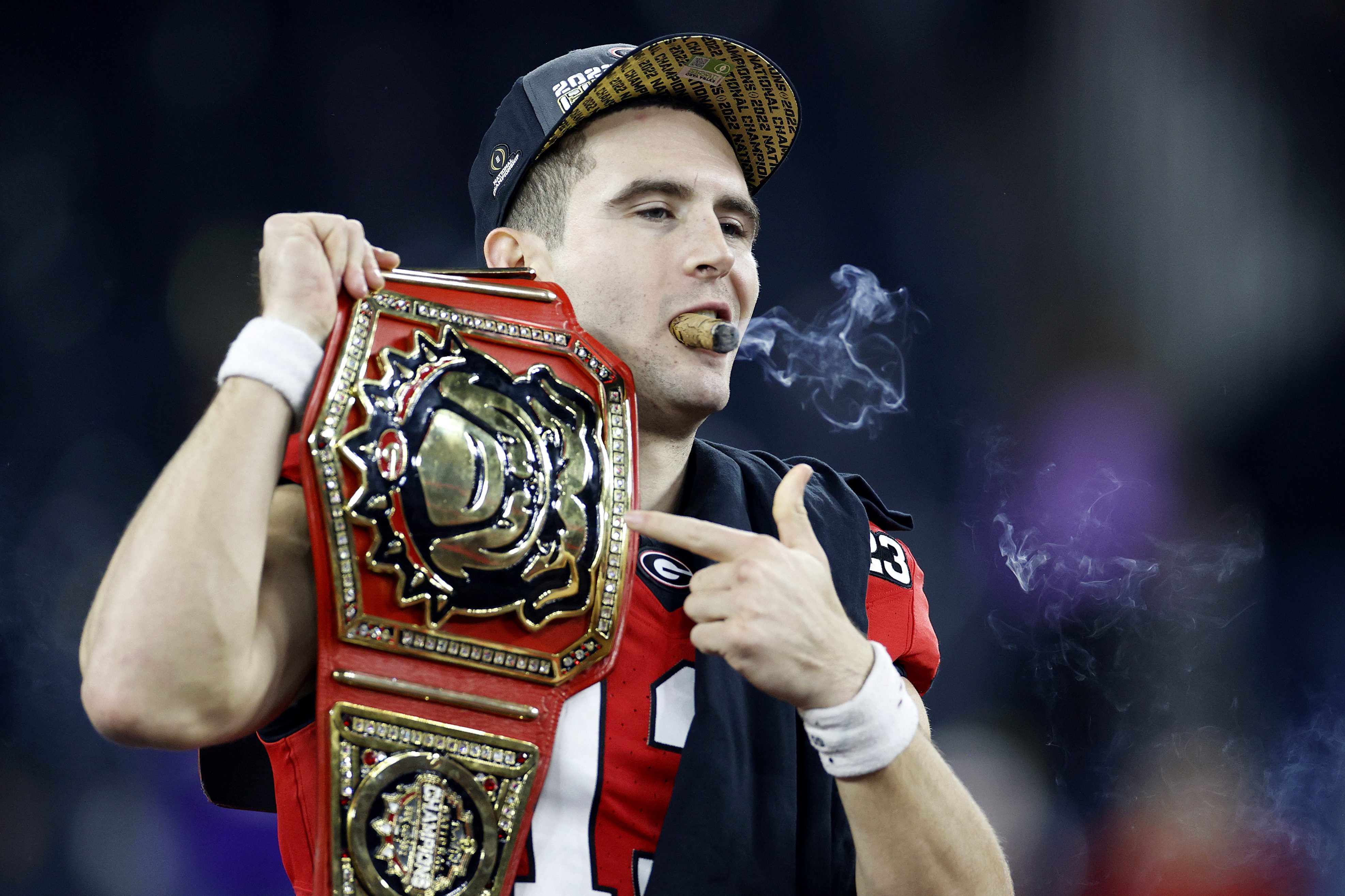 Stetson Bennett of the Georgia Bulldogs celebrates with a cigar.