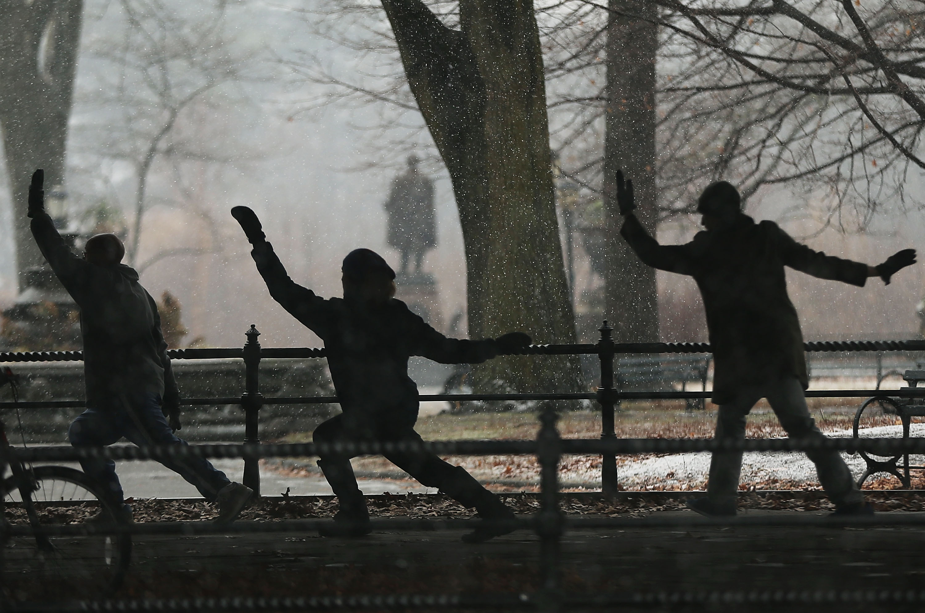 A group practicing Tai Chi on a cold day in a New York City park.