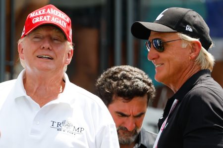 Donald Trump talks with LIV Golf CEO Greg Norman at an LIV event.
