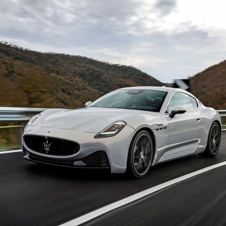 A white 2024 Maserati GranTurismo Modena driving around Italian roads. We tested and reviewed the new grand touring sports car.