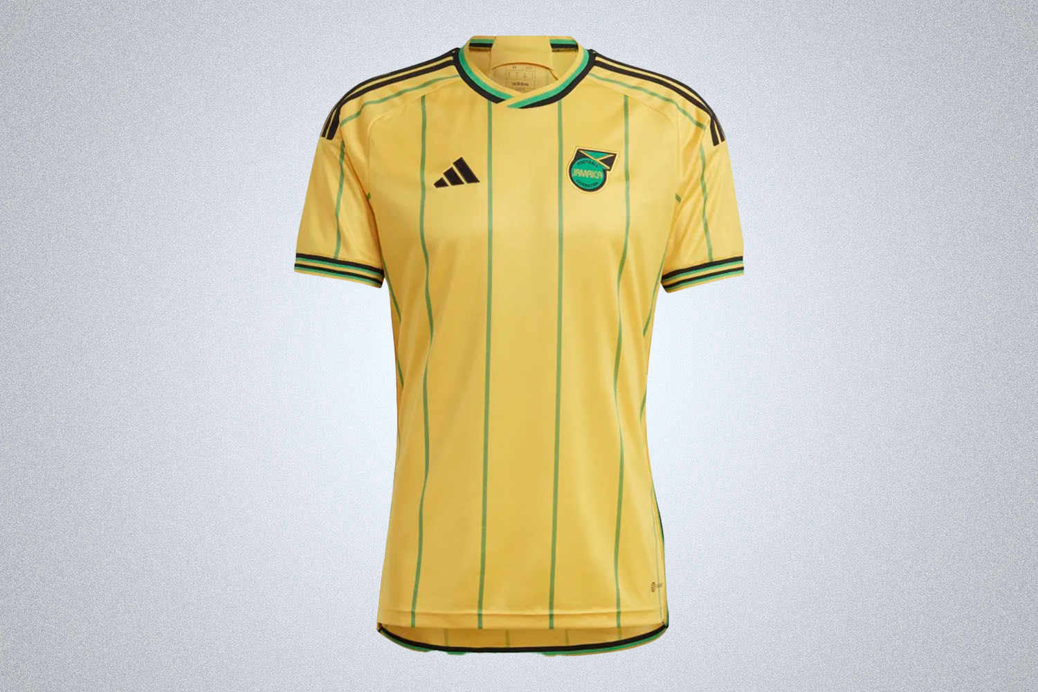 a yellow and green striped Adidas Jamaica 23 Home Kit on a grey background