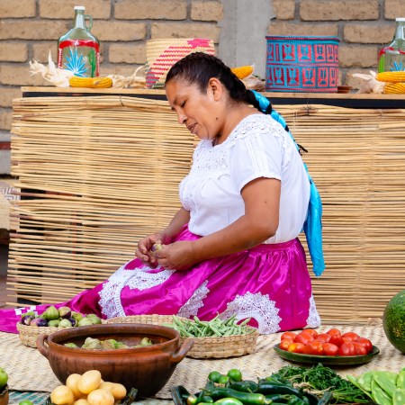 Mimi Lopez Hernandez sitting around bowls of traditional oaxacan ingredients