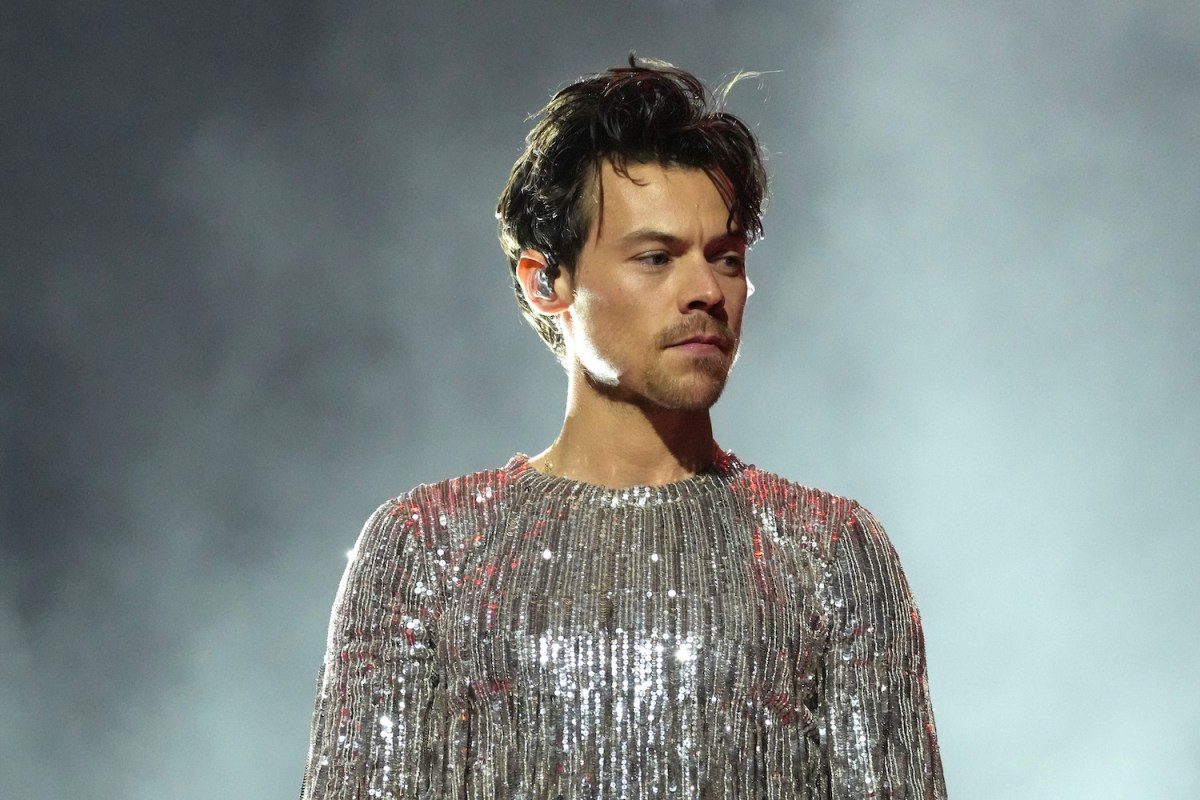 a photo of Harry Styles in a silver jumpsuit at the 65th GRAMMY Awards.