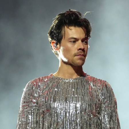 a photo of Harry Styles in a silver jumpsuit at the 65th GRAMMY Awards.