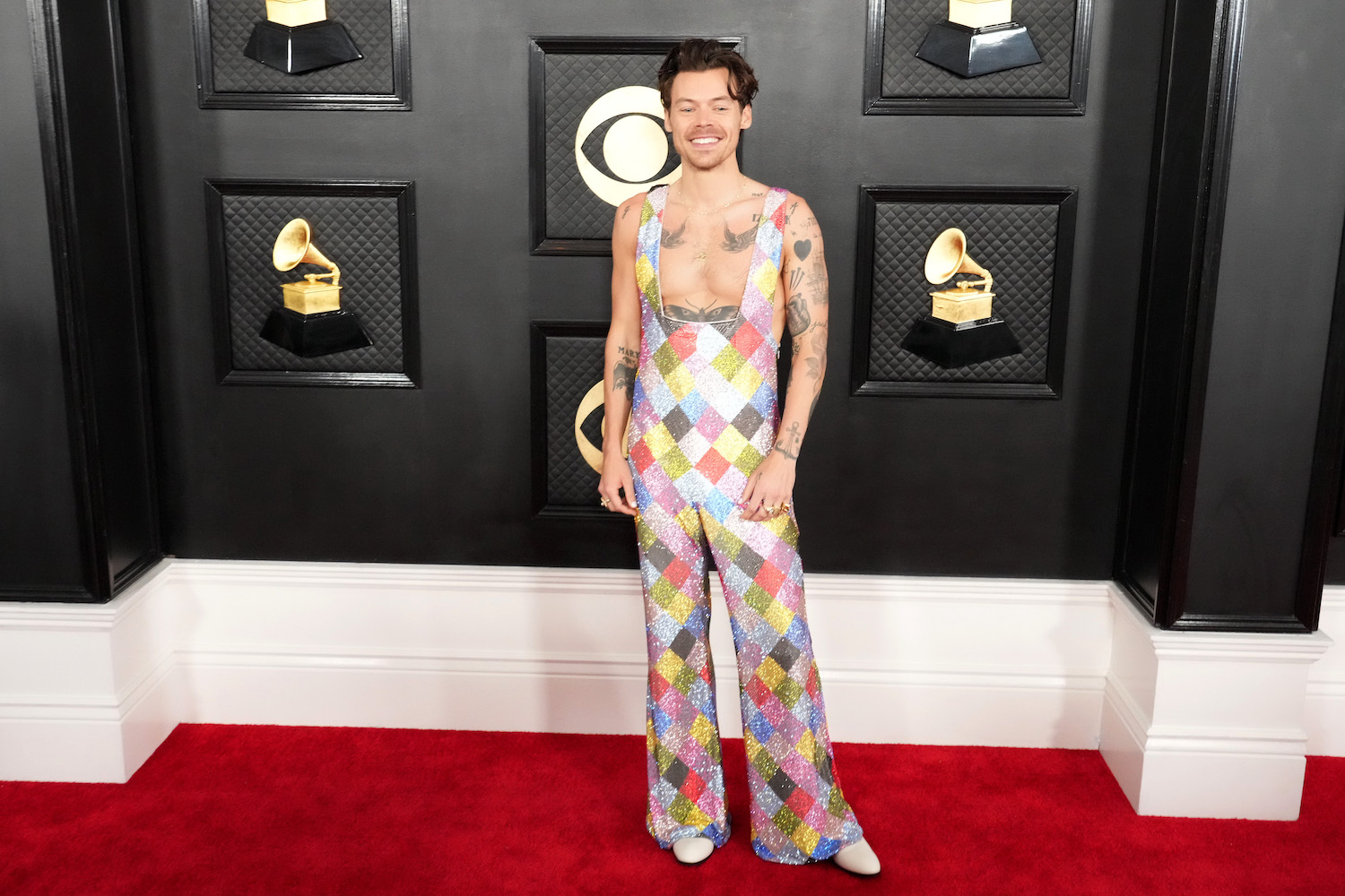 a photo of Harry Styles in a sequined jumpsuit at the 65th GRAMMY Awards.