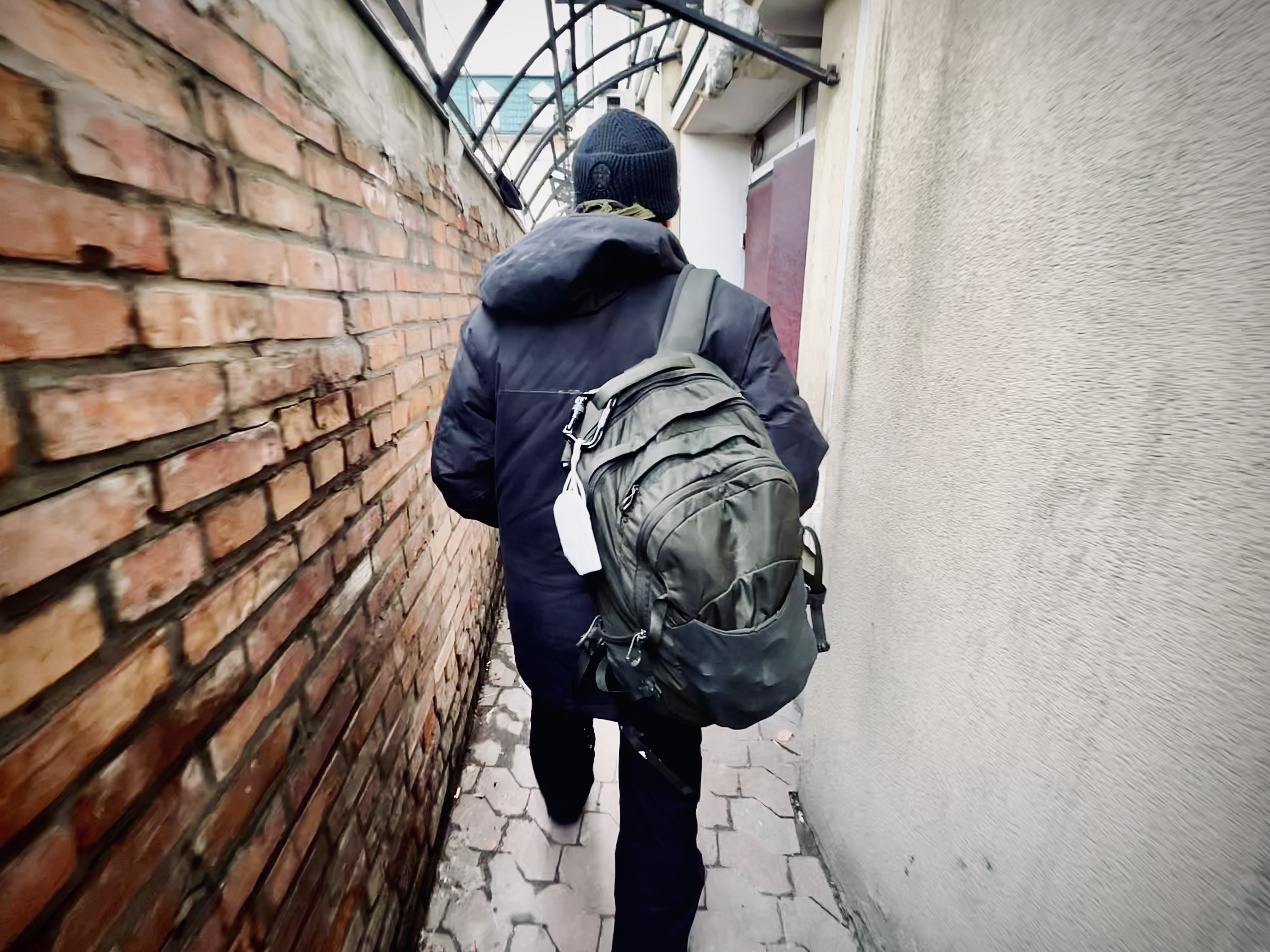 man with a backpack moving through the streets of Kyiv