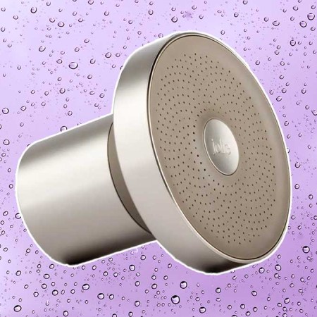 The Filtered Showerhead from Jolie, on a purple backgrund with water droplets