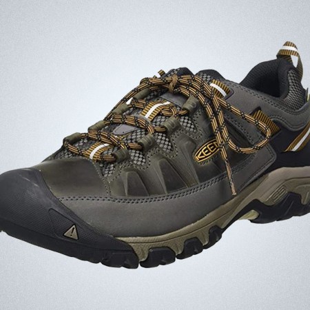 a grey and brown Keen hiking shoe on a grey background