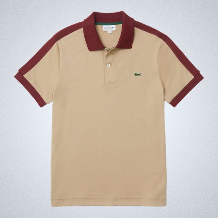 a tan Lacoste Constrast Collar Polo with red liniing on a grey background