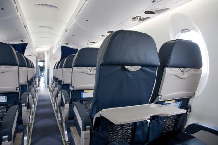 Rows of airplane seats, which, according to CNN, are slowly starting to lose the reclining function
