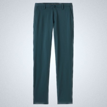 a pair of blue Rhone Commuter Pants on a grey background