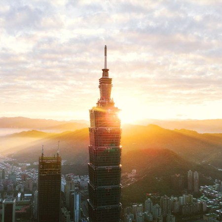 Taipei 101 Tower in Taiwan with the sun shining in the background