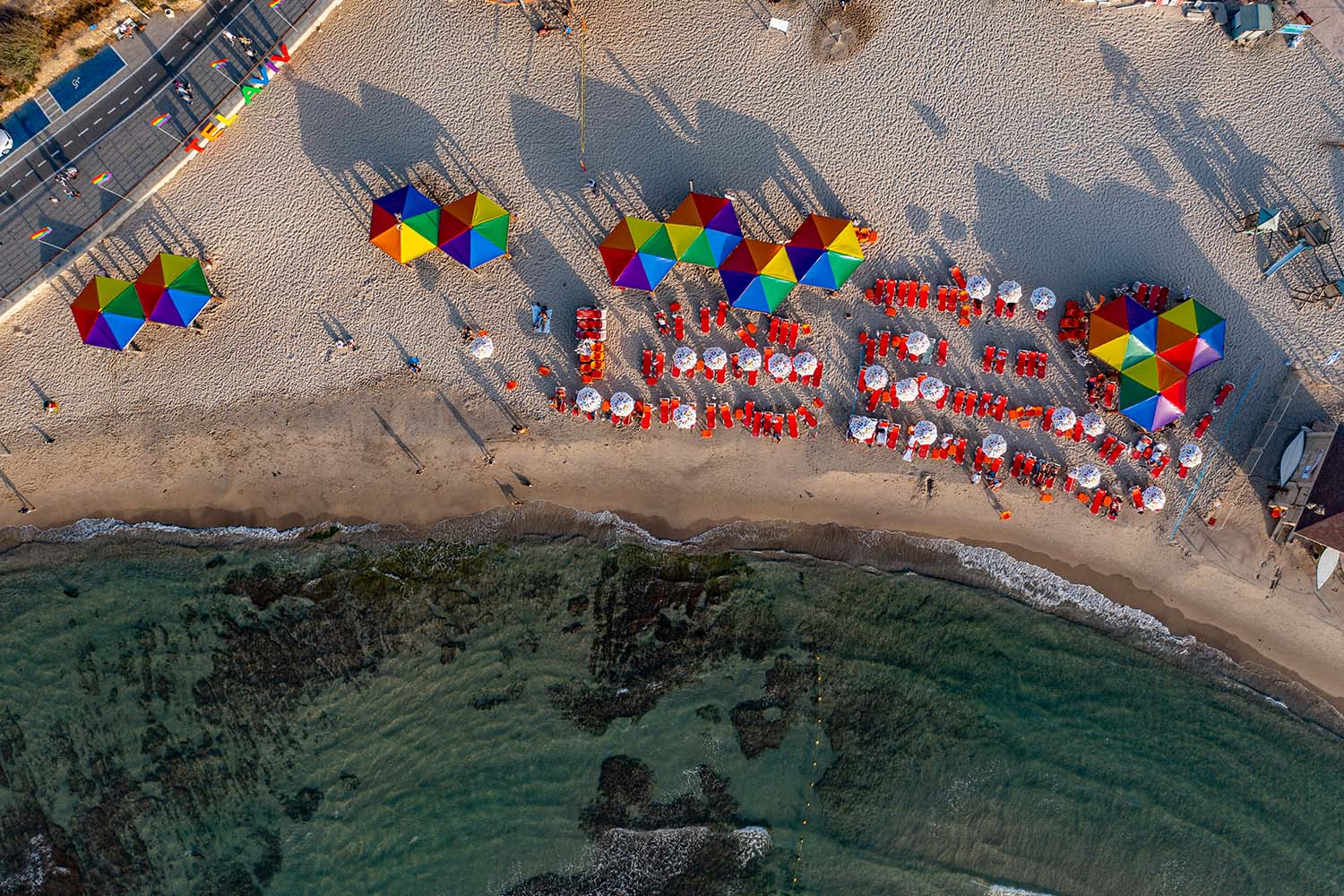 Aerial view of Hilton Beach with rainbow umbrellas