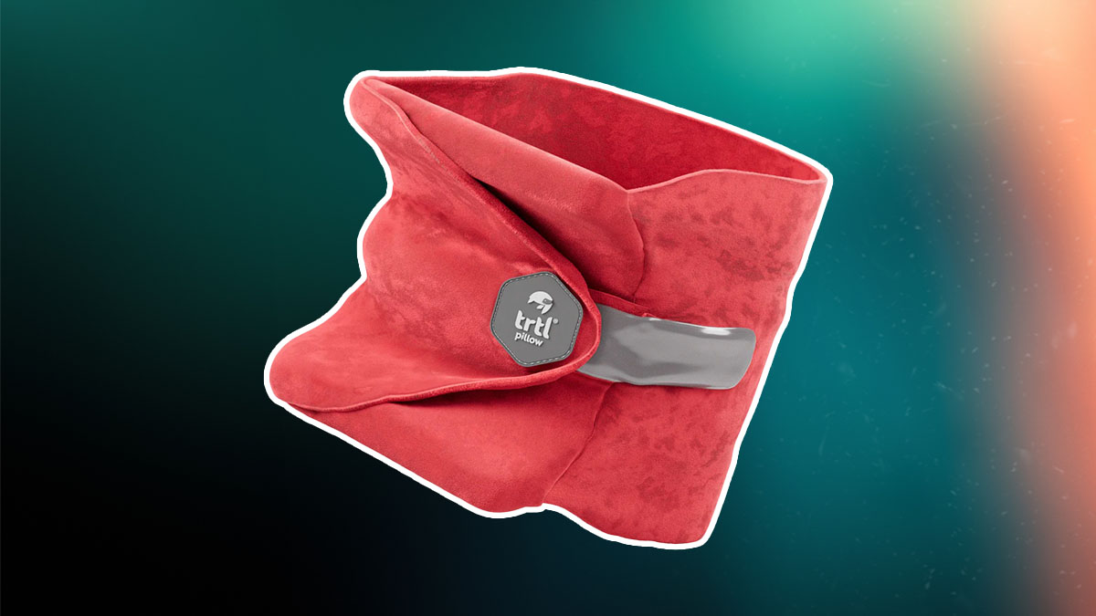 The Trtl Travel neck pillow on a green and red background