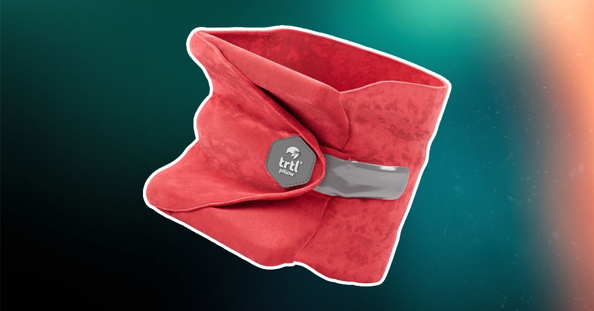 The Trtl Travel neck pillow on a green and red background