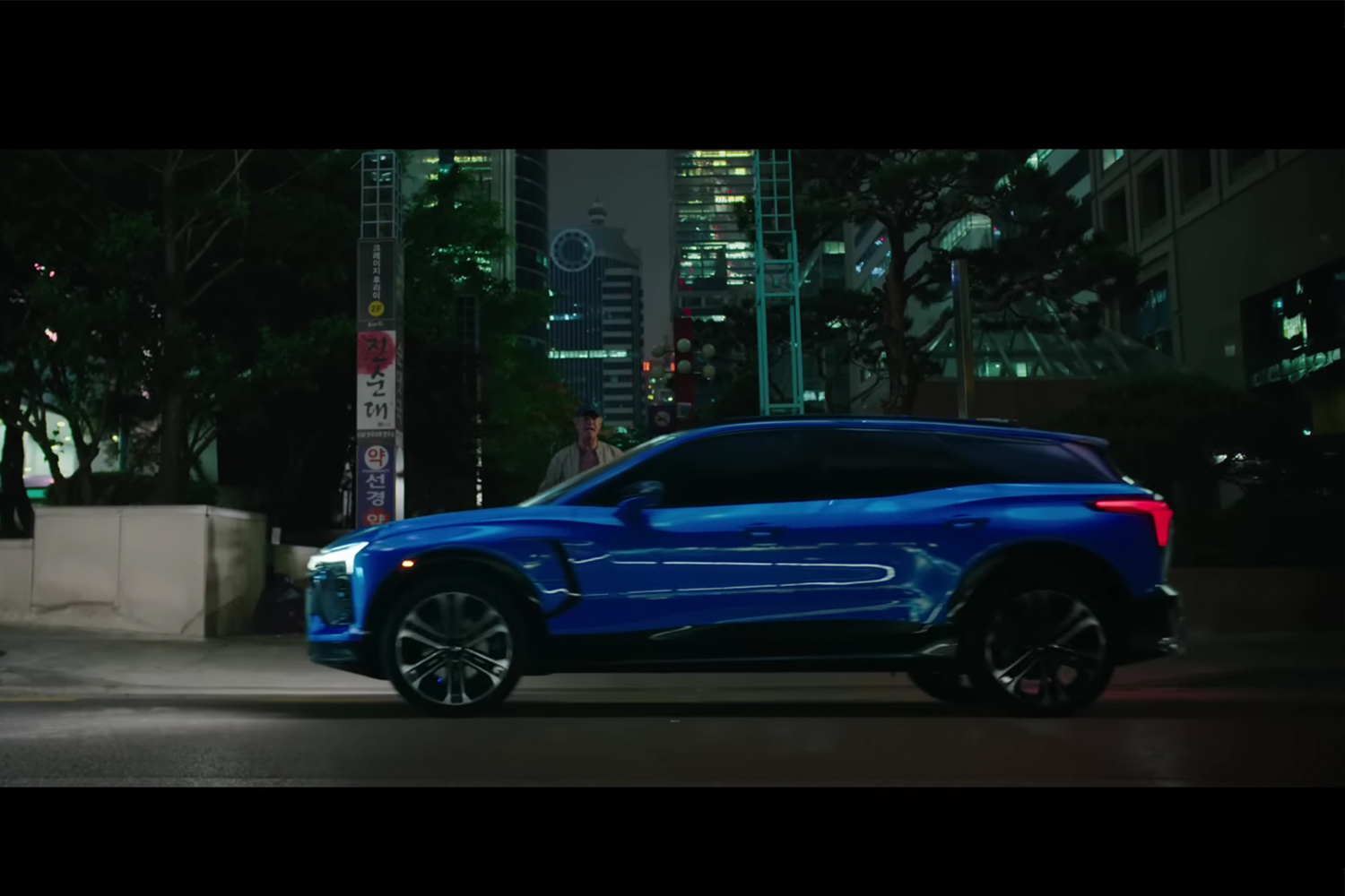 Will Ferrell stands next to the Chevrolet Blazer EV in a scene from "Squid Game"