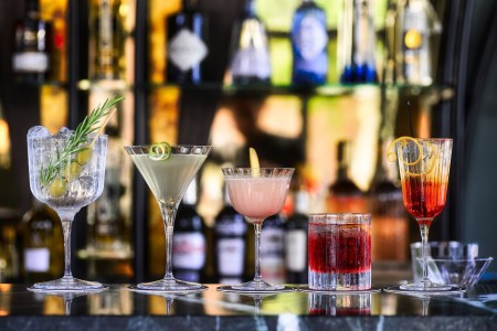Several types of cocktails on a bar counter. According to one new study, cocktail prices are up by an average of $1 per drink.