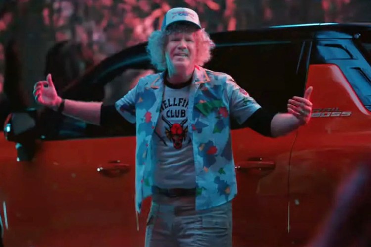 Will Ferrell, dressed as Dustin Henderson from "Stranger Things," stands in front of a Chevrolet Silverado EV Trail Boss in a Super Bowl ad from GM and Netflix