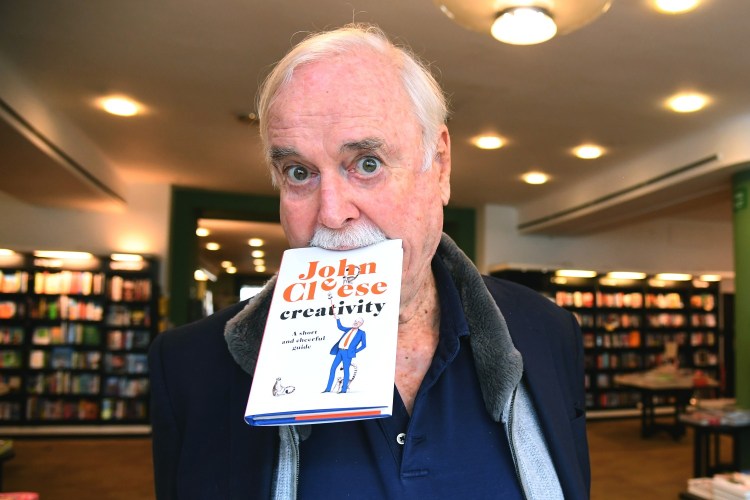 John Cleese with book