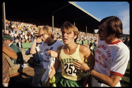 Steve Prefontaine tired after finishing a race, in his Oregon track jersey.