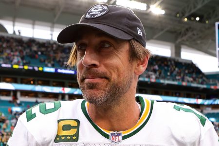 Aaron Rodgers walks off the field after beating the Dolphins in December. To kick off Super Bowl week, the Packers quarterback is speaking at an astrology workshop.