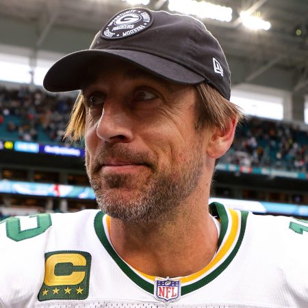Aaron Rodgers walks off the field after beating the Dolphins in December. To kick off Super Bowl week, the Packers quarterback is speaking at an astrology workshop.