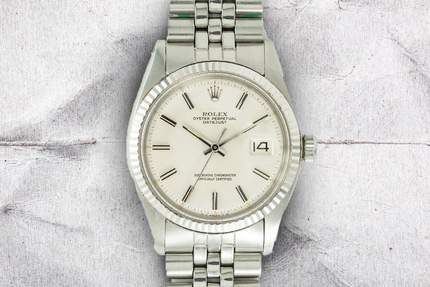 A great vintage watch under $10,000, the Rolex DateJust Ref 1601 on a gray background