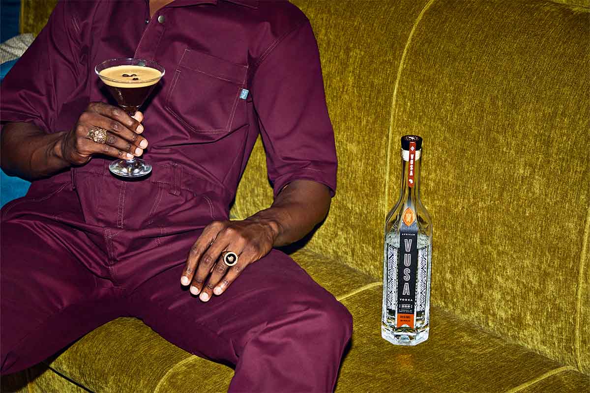 A man on a couch drinking an espreso martini utilizing Vusa vodka from Spearhead Spirits