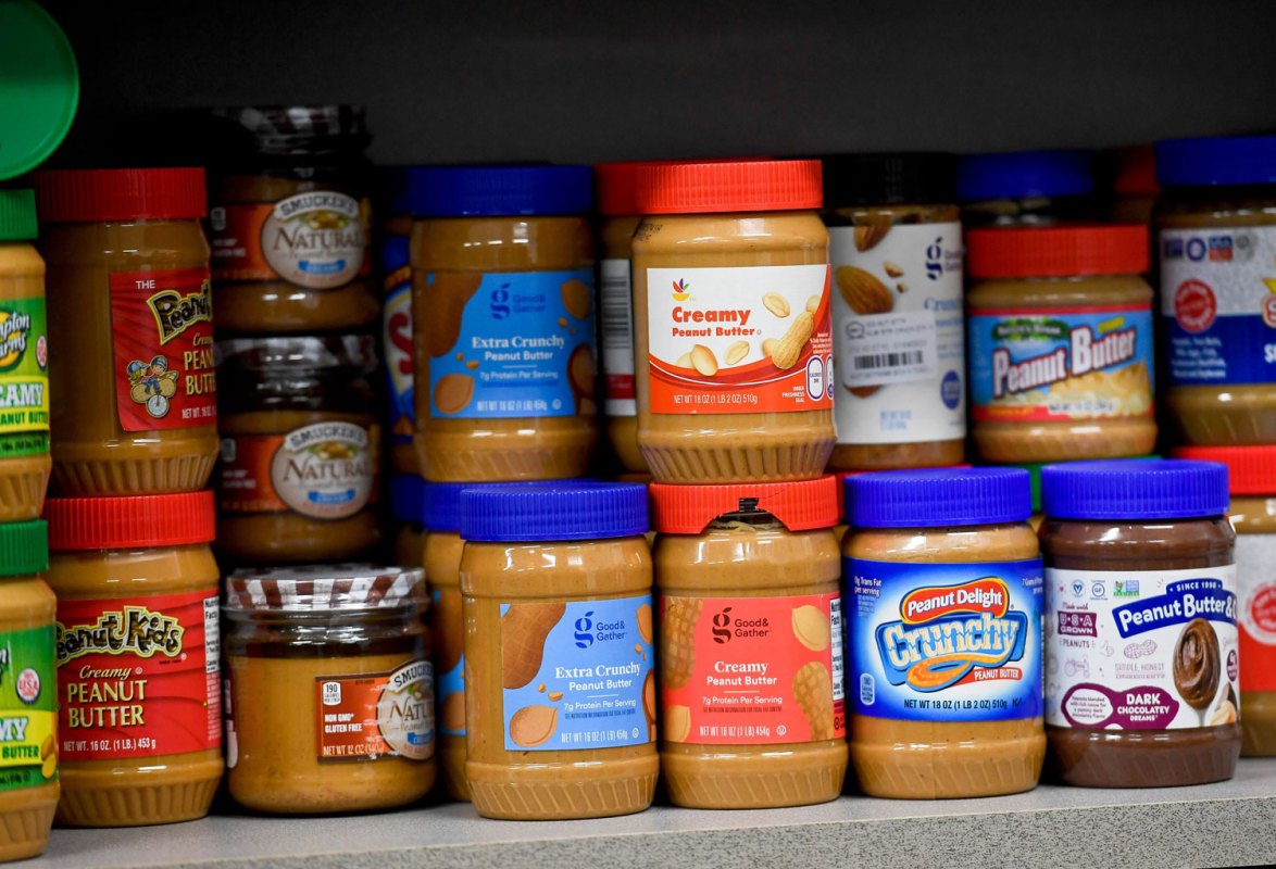 A shelf of peanut butter at the grocery store.