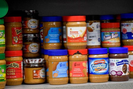 A shelf of peanut butter at the grocery store.