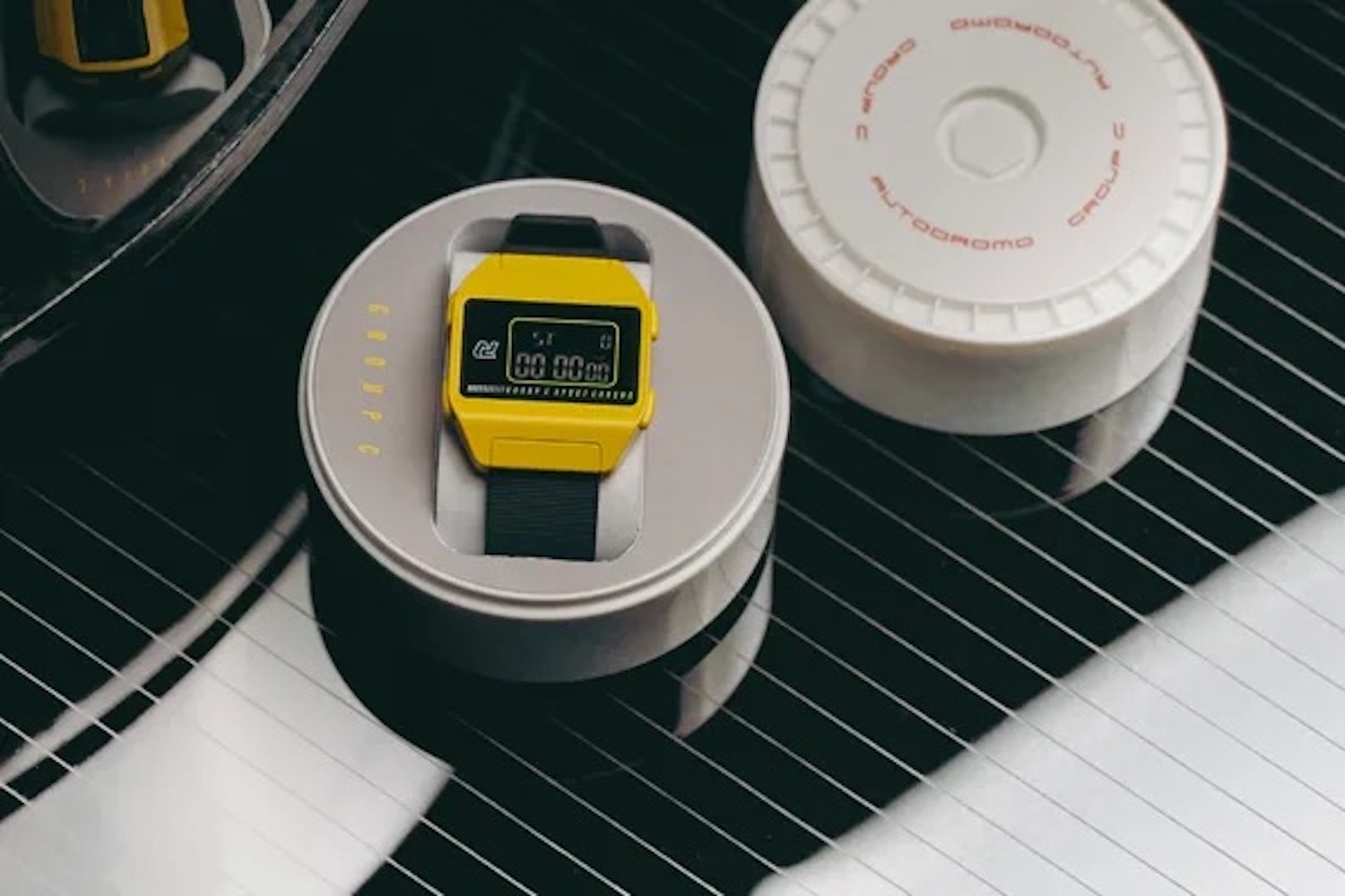 a yellow Autodromo in a grey case on a table