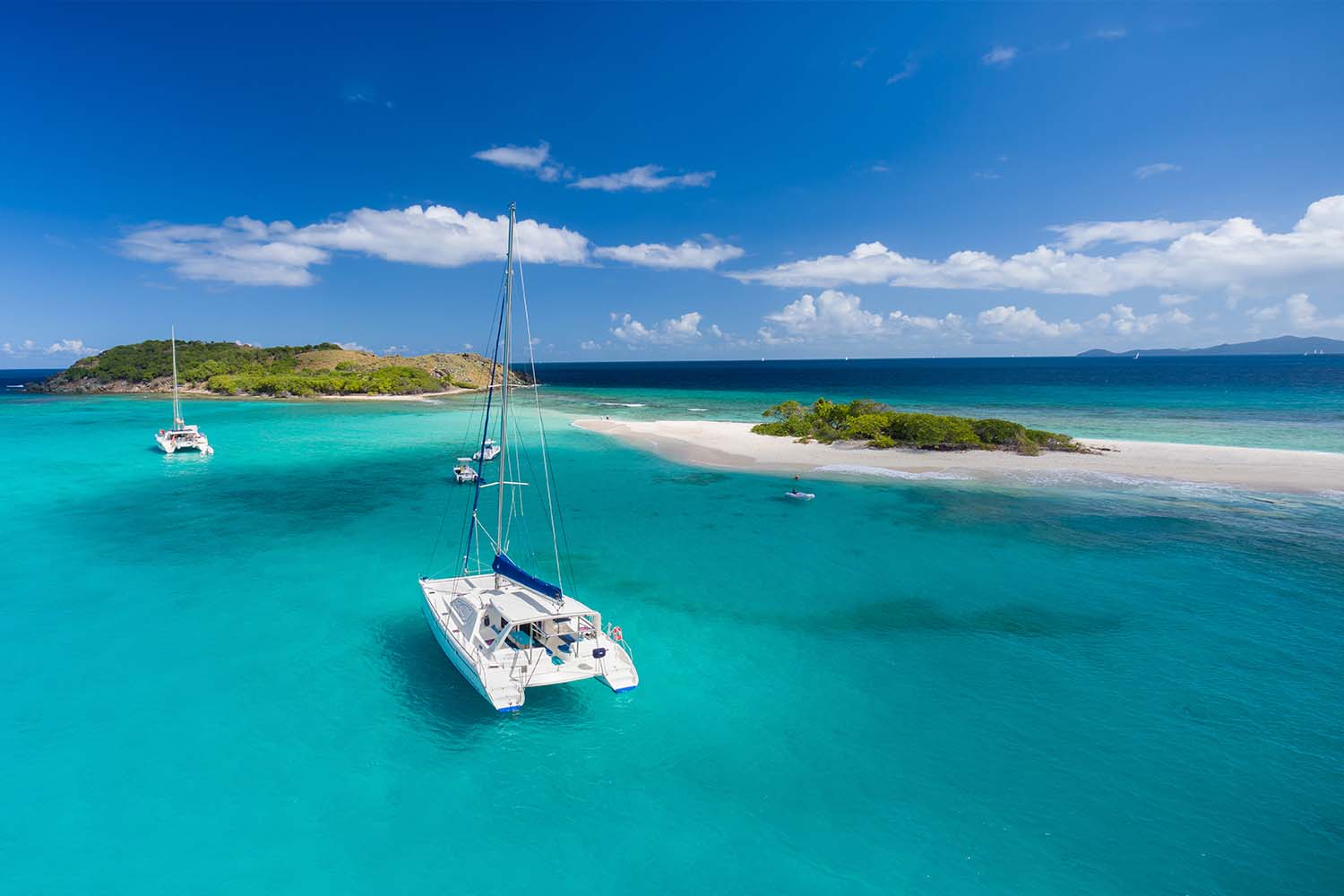 Aerial view of a catamaran at anchor in front of Sandy Spit, British Virgin Islands