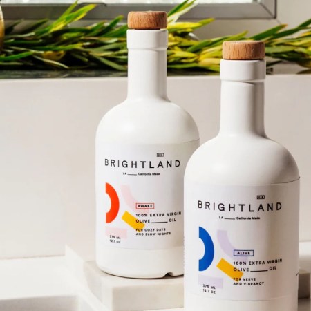 a duo of Brightland Olive Oil Bottles on a marble countertop