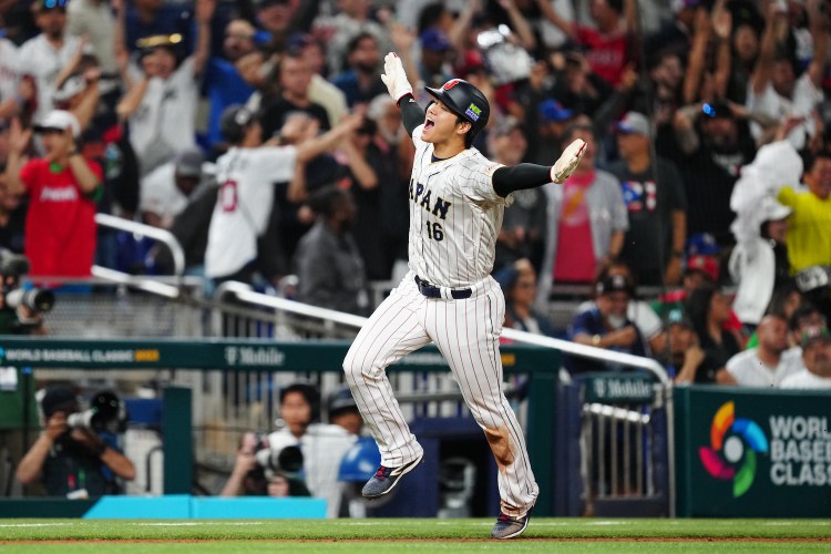 Shohei Ohtani #16 of Team Japan rounds the bases to score on a three-run home run hit by Masataka Yoshida #34 in the seventh inning during the 2023 World Baseball Classic Semifinal game between Team Mexico and Team Japan at loanDepot Park on Monday, March 20, 2023 in Miami, Florida