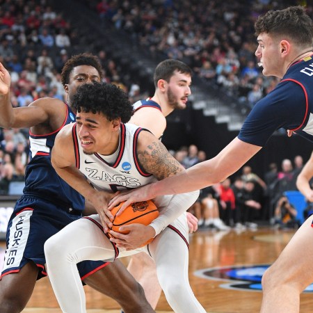 Gonzaga guard Julian Strawther (0) is tied up by UConn Huskies center Donovan Clingan (32) during the NCAA Division I Men's Championship Elite Eight round basketball game between the Gonzaga Bulldogs and the UConn Huskies on March 25, 2023 at T-Mobile Arena in Las Vegas, NV.