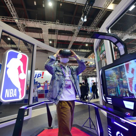 A visitor wears a VR headset at the NBA stand during the 3rd China International Import Expo (CIIE) at the National Exhibition and Convention Center on November 9, 2020 in Shanghai, China.