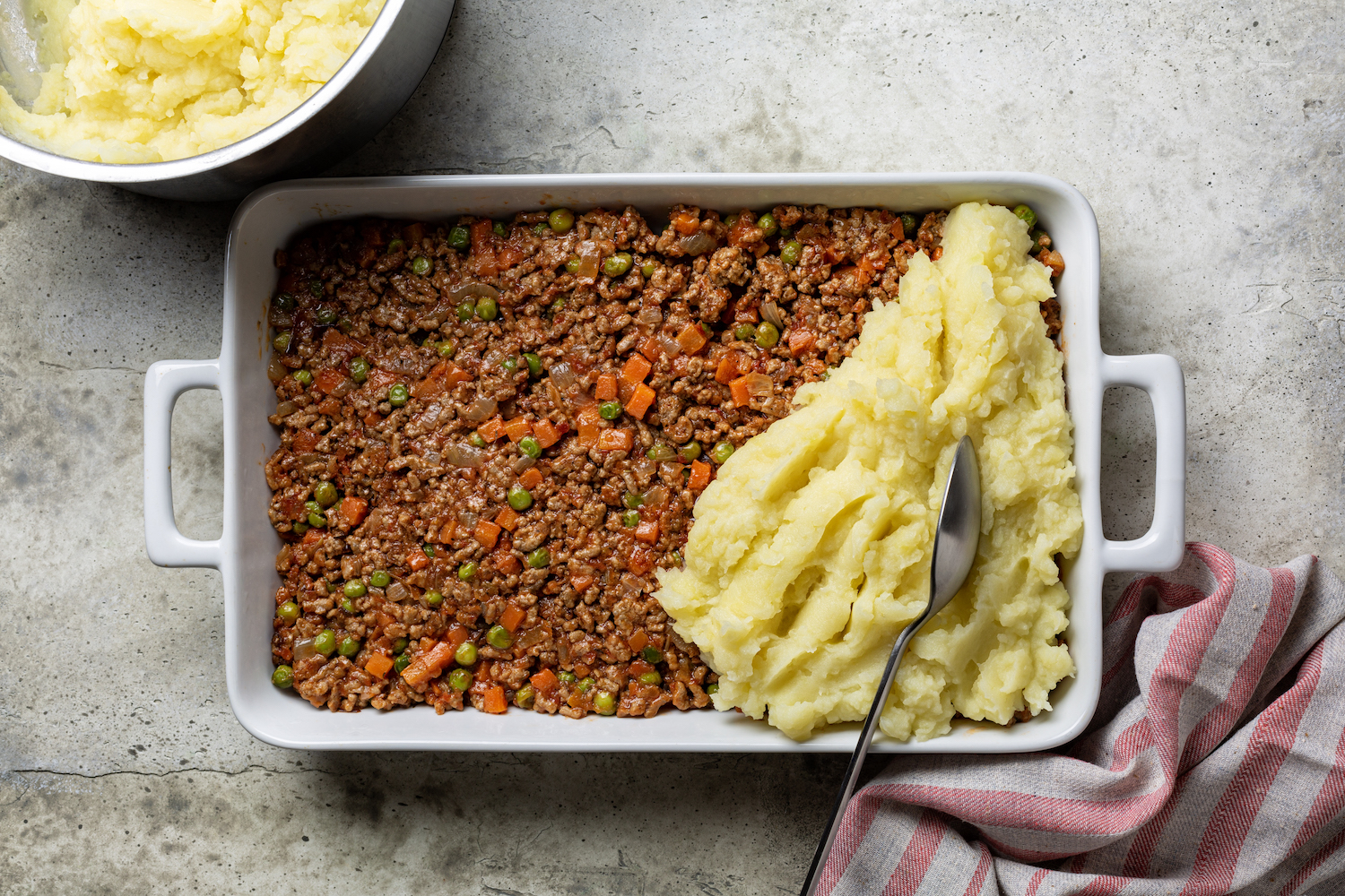 shepherd's pie with ground lamb and vegetables topped with mashed potatos