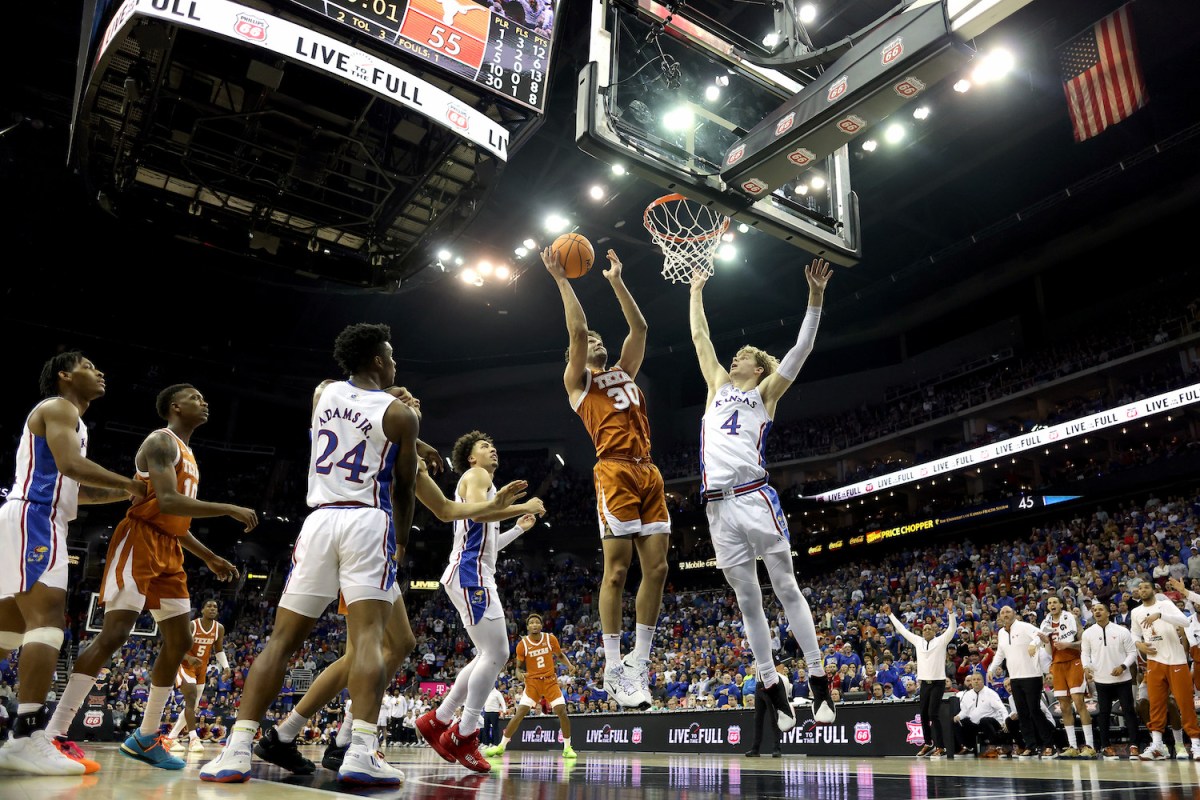 Brock Cunningham #30 of the Texas Longhorns shoots the ball against Gradey Dick #4 of the Kansas Jayhawks during second half of the Big 12 Tournament Championship game at T-Mobile Center on March 11, 2023 in Kansas City, Missouri.