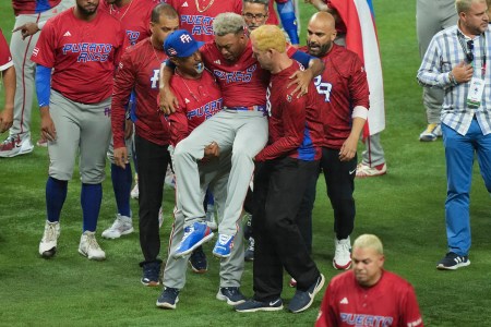 Edwin Diaz #39 of Puerto Rico is helped off the field after being injured during the on-field celebration after defeating the Dominican Republic during the World Baseball Classic Pool D at loanDepot park on March 15, 2023 in Miami, Florida.